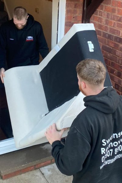 Swansea Removals team handling a wrapped large item